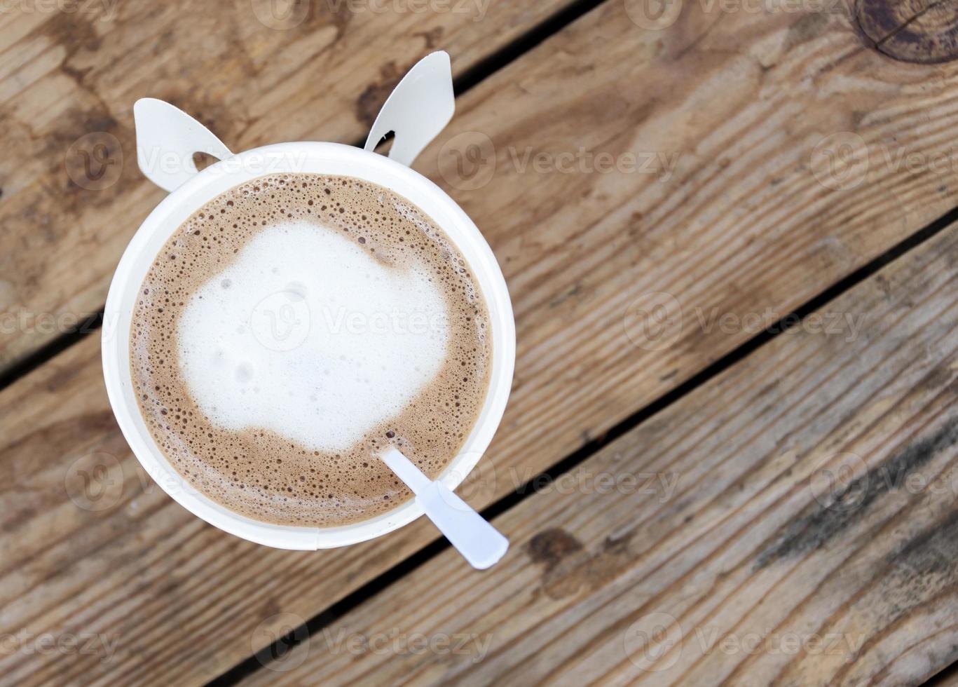 Top view mocha coffee in white cup on wooden table photo