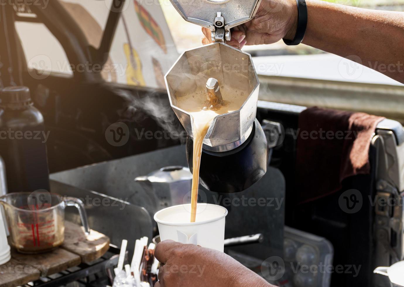 Barista making coffee with moka pot photo