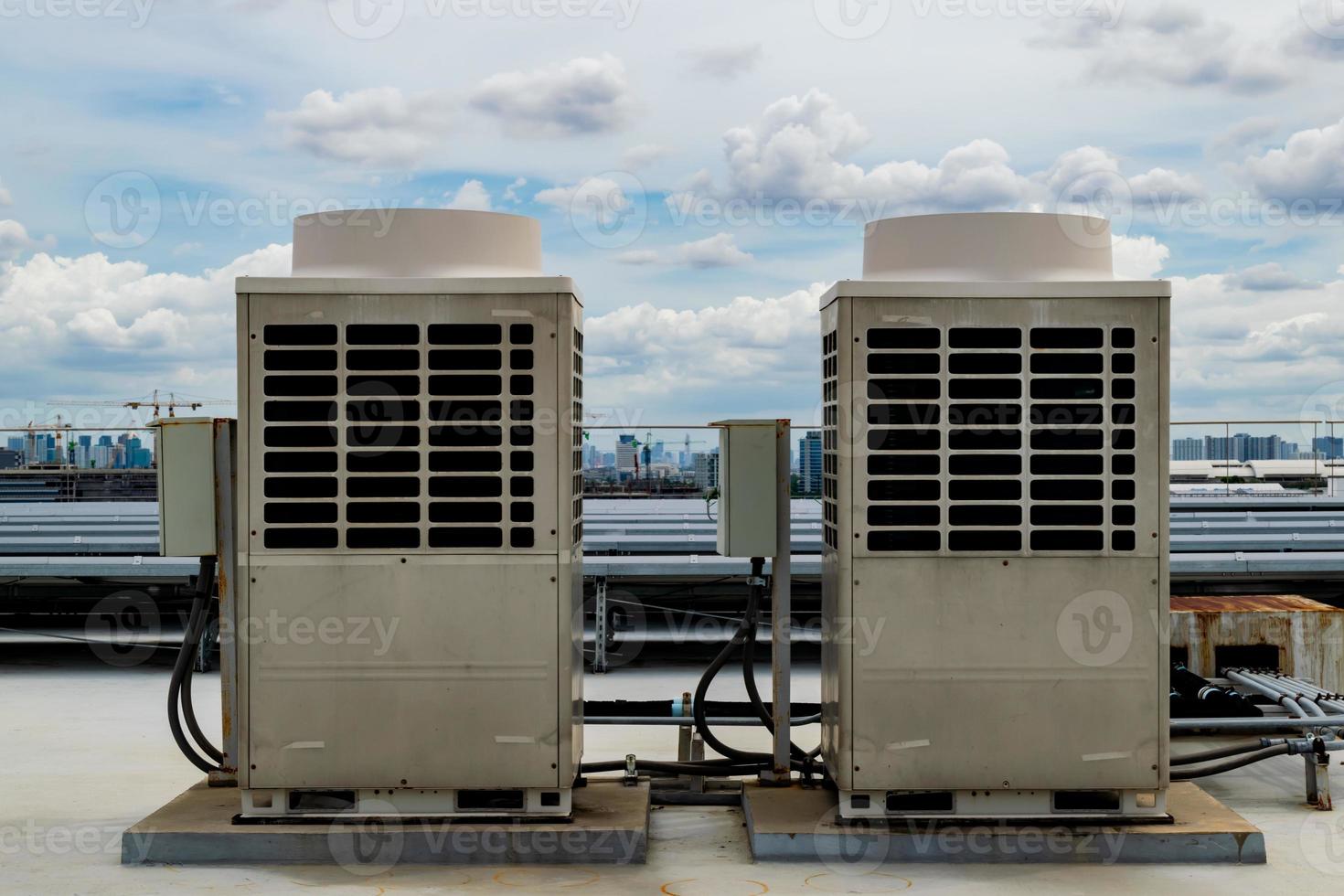 Air conditioner units HVAC on a roof of industrial building with blue sky. photo