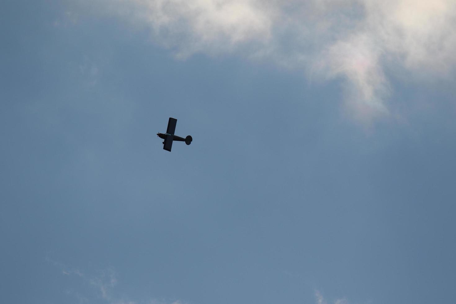Small plane flying on a blue sky photo