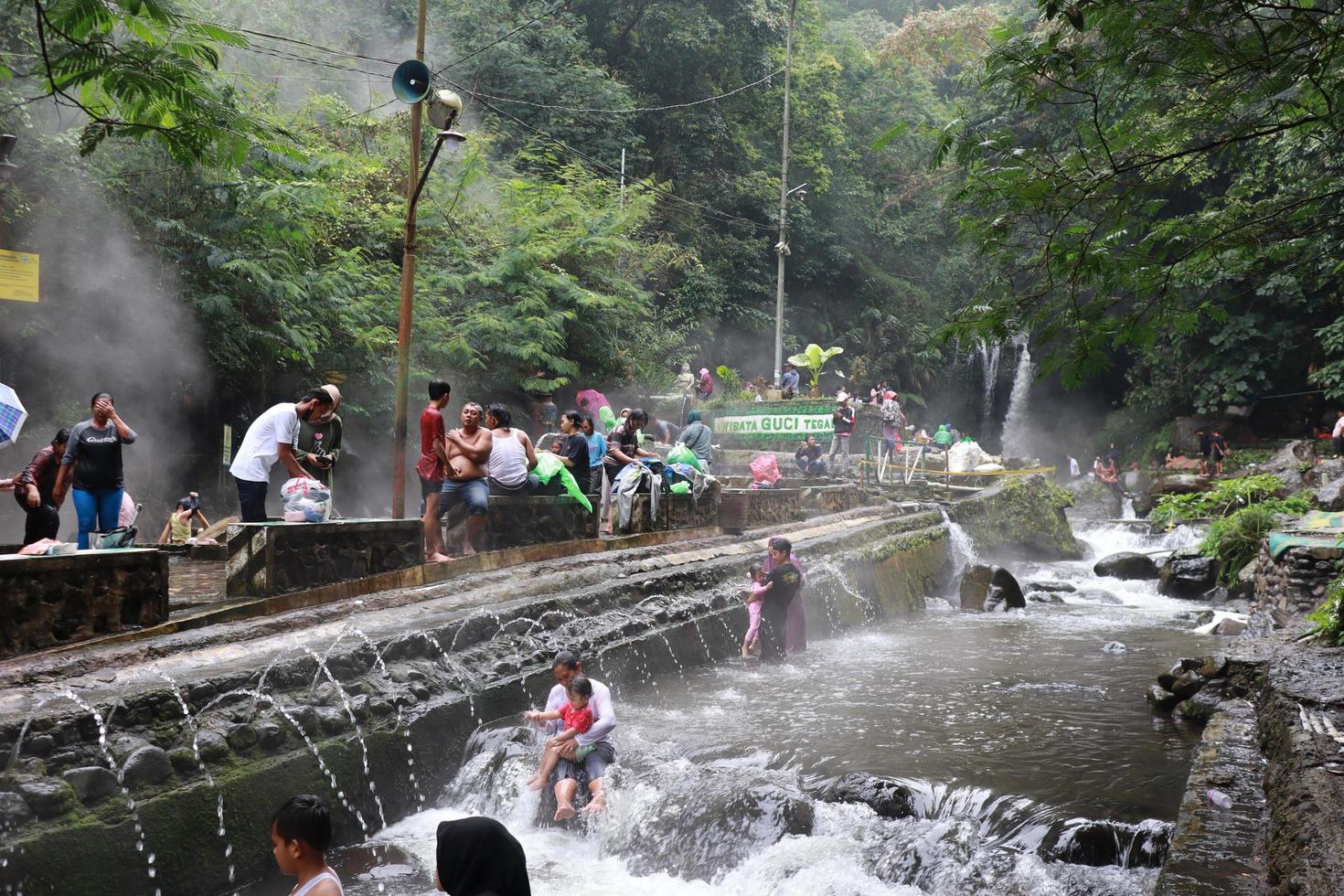 Tegal, January 2023. Photo of busy visitors relaxing and enjoying the Guci hot spring bath.