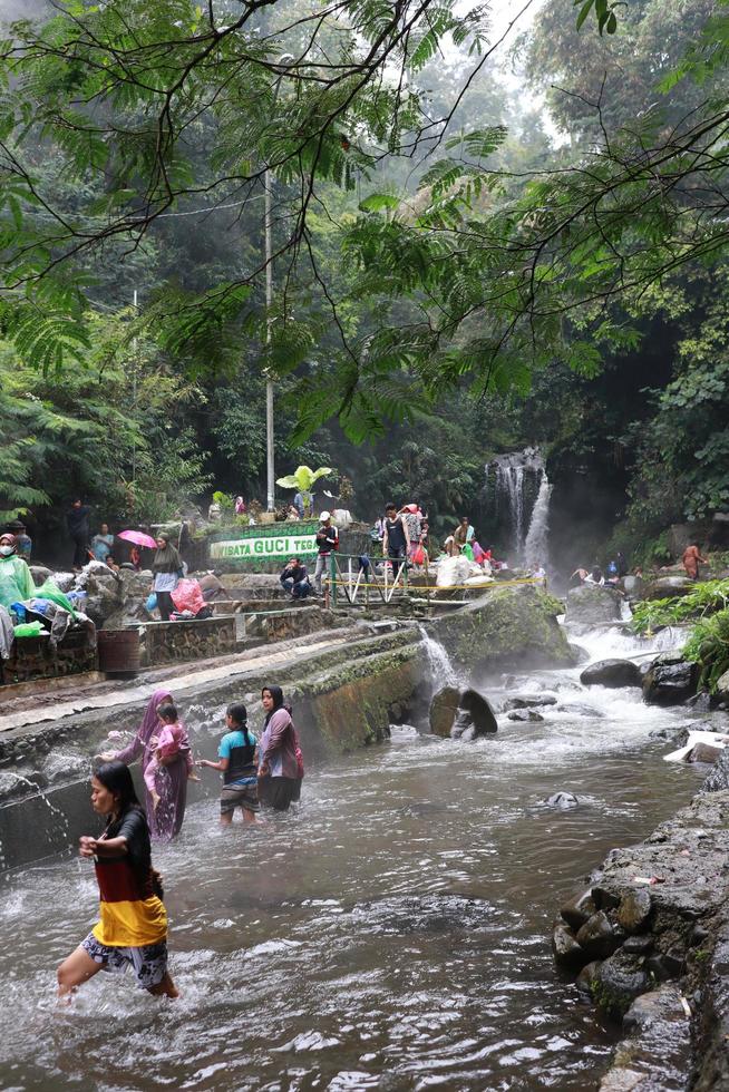 Tegal, January 2023. Photo of busy visitors relaxing and enjoying the Guci hot spring bath.
