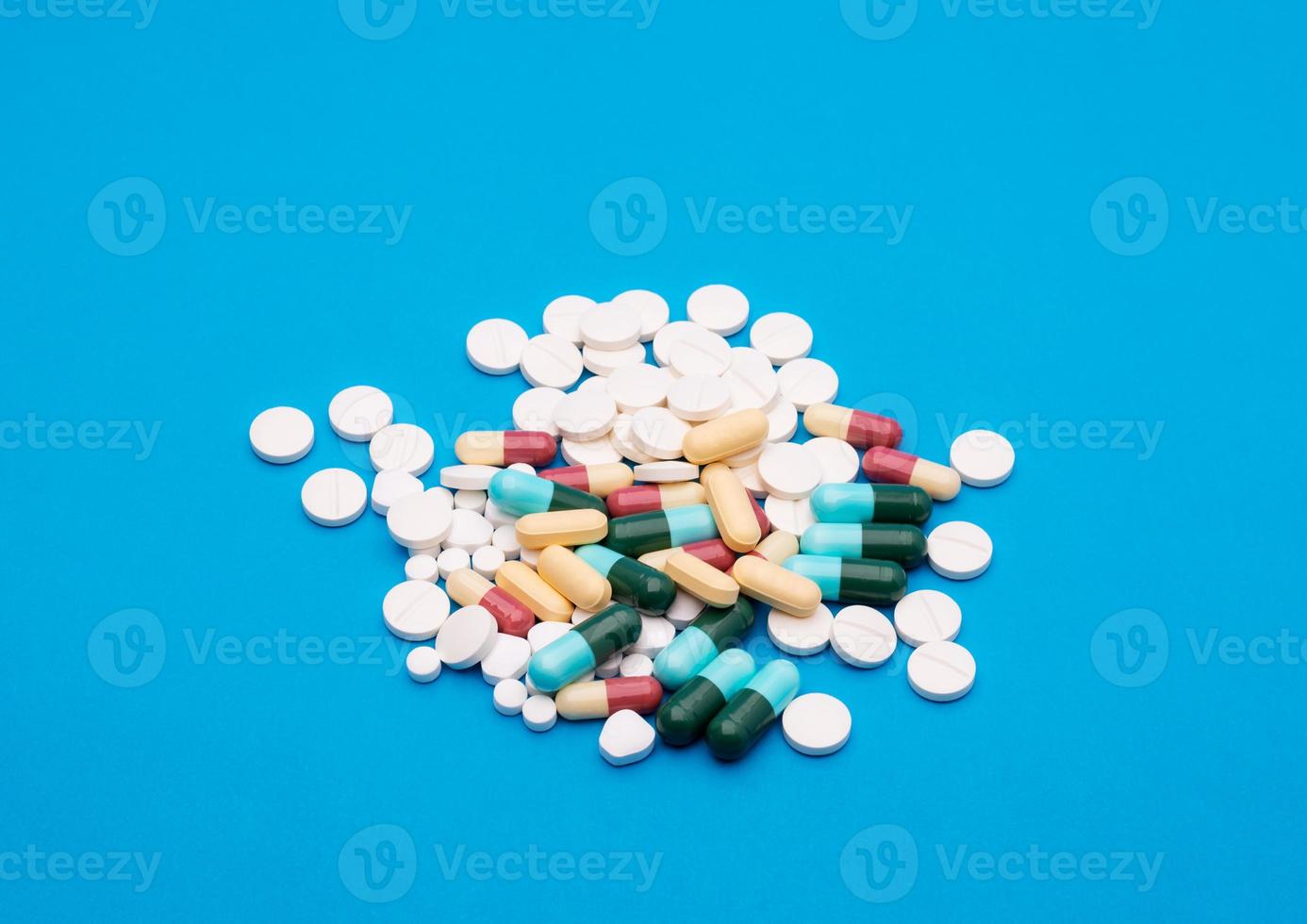 green capsule pill on blue background table medicine vitamin antibiotic