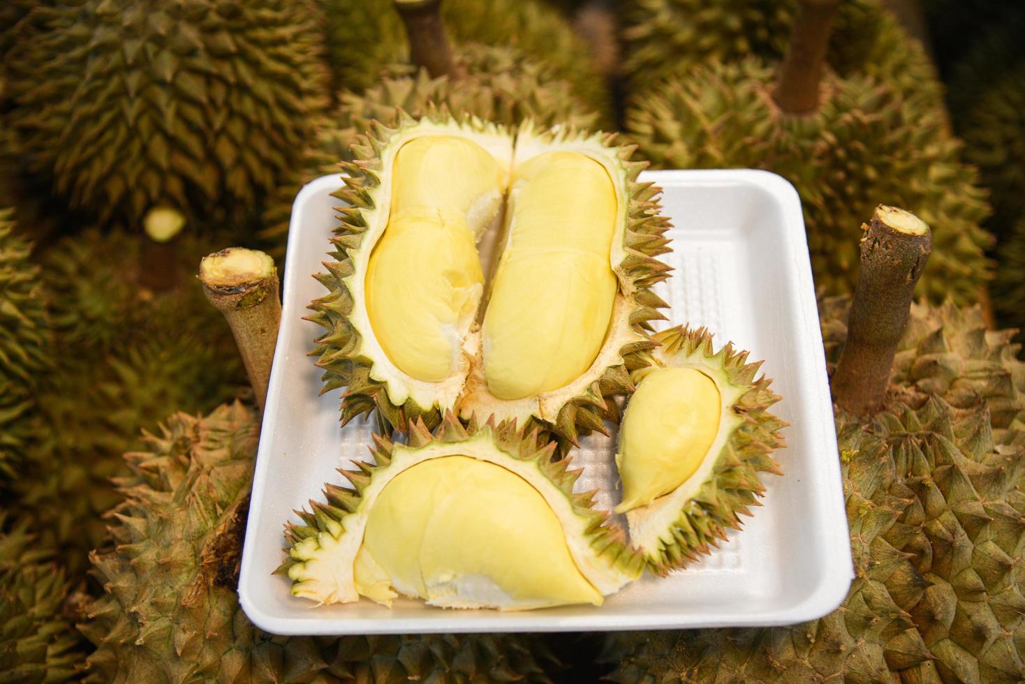 Fresh durian peeled on tray and ripe durian tropical fruit photo
