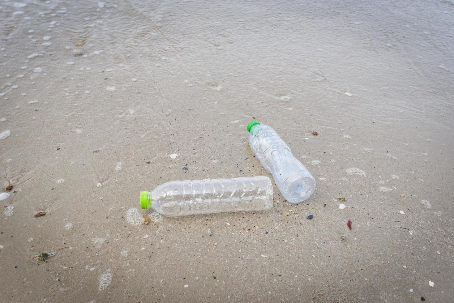 Garbage in the sea with plastic bottle on beach sandy dirty sea on the island - Environmental problem of plastic rubbish pollution in ocean photo