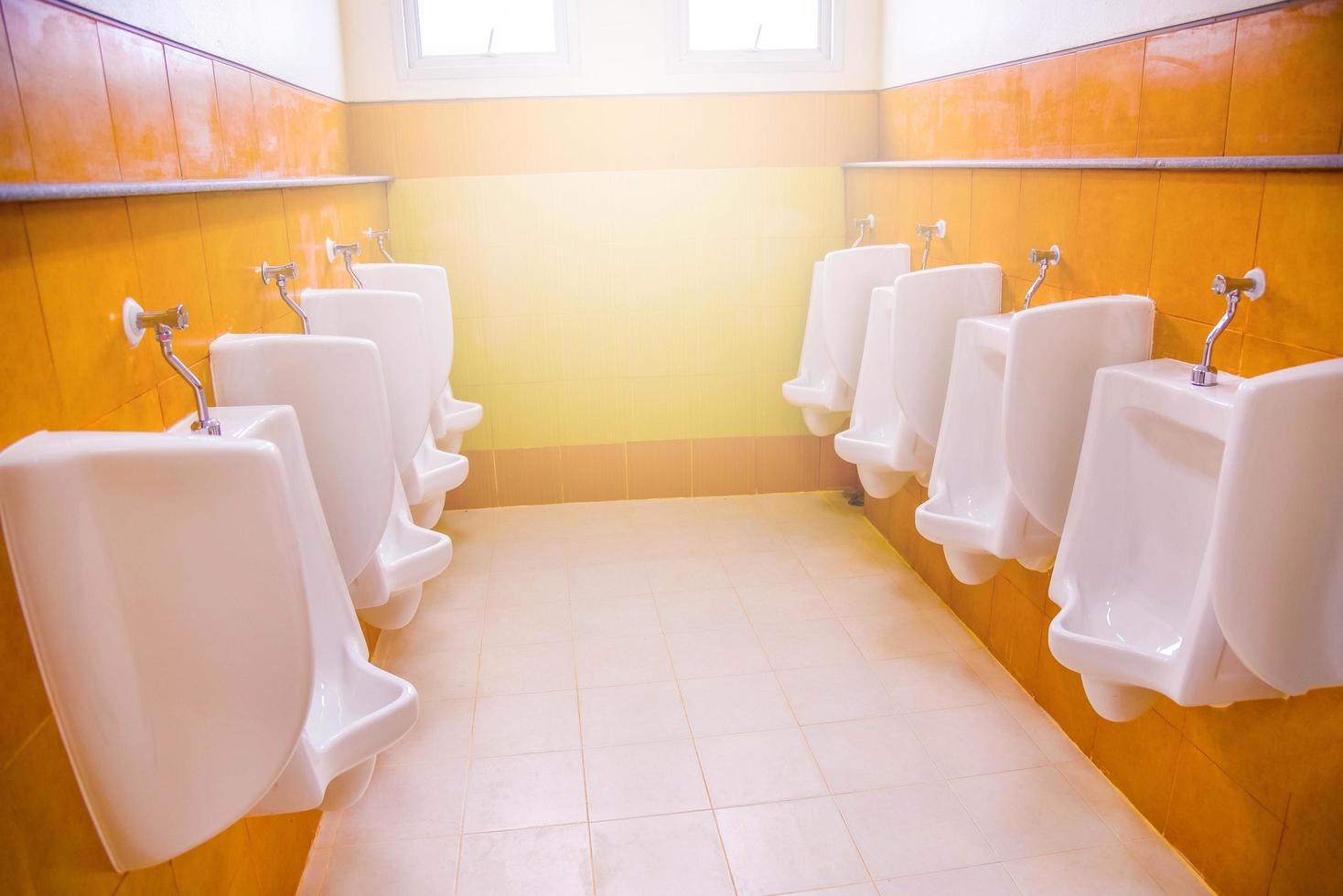 urinal toilet blocks for man row on tiled wall in public toilet photo