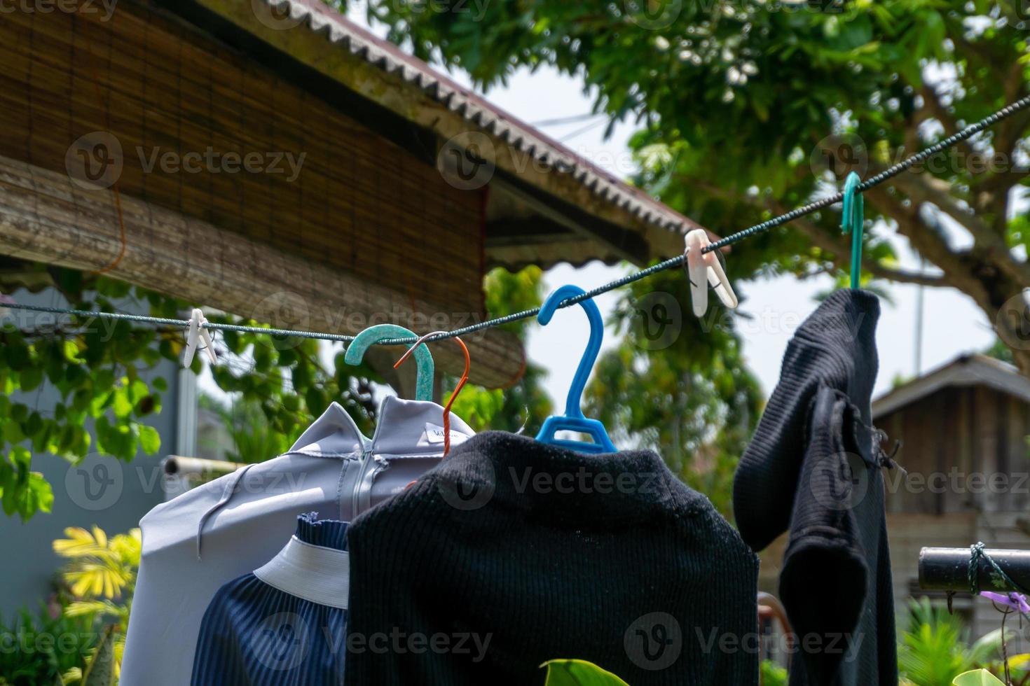 Clothes hangin in clothesline at sunny day photo