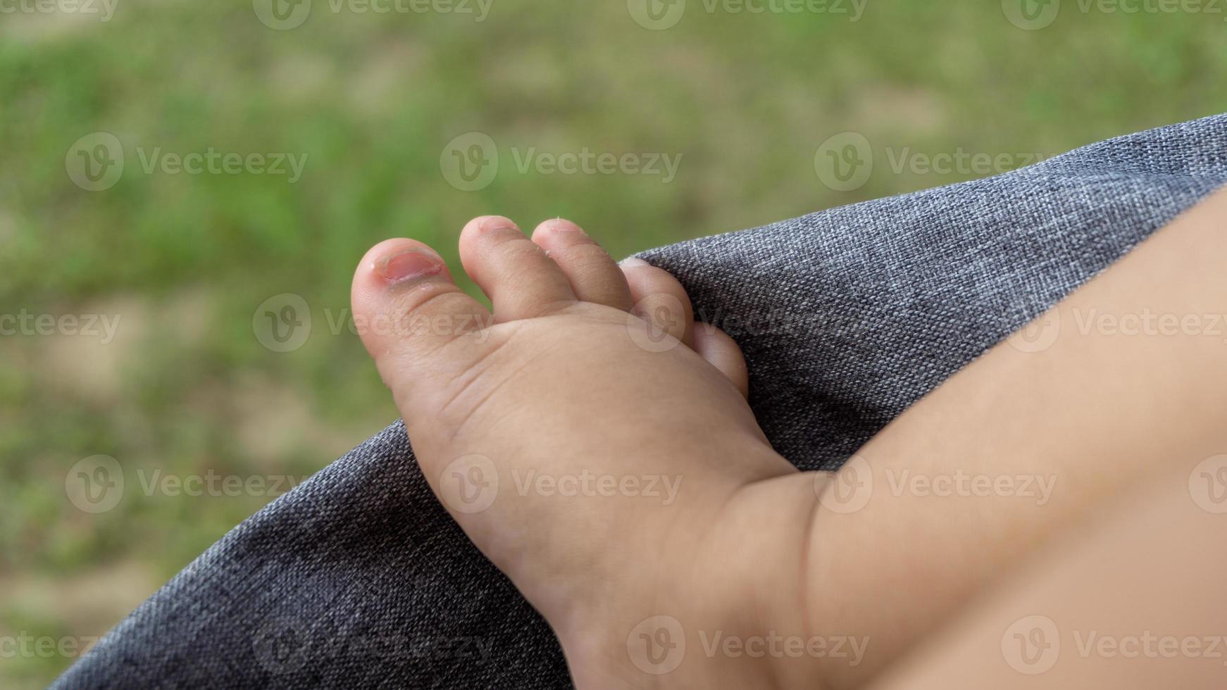 Close up of baby tiny feet. baby foot on stroller. Infant boy tiny feet. photo