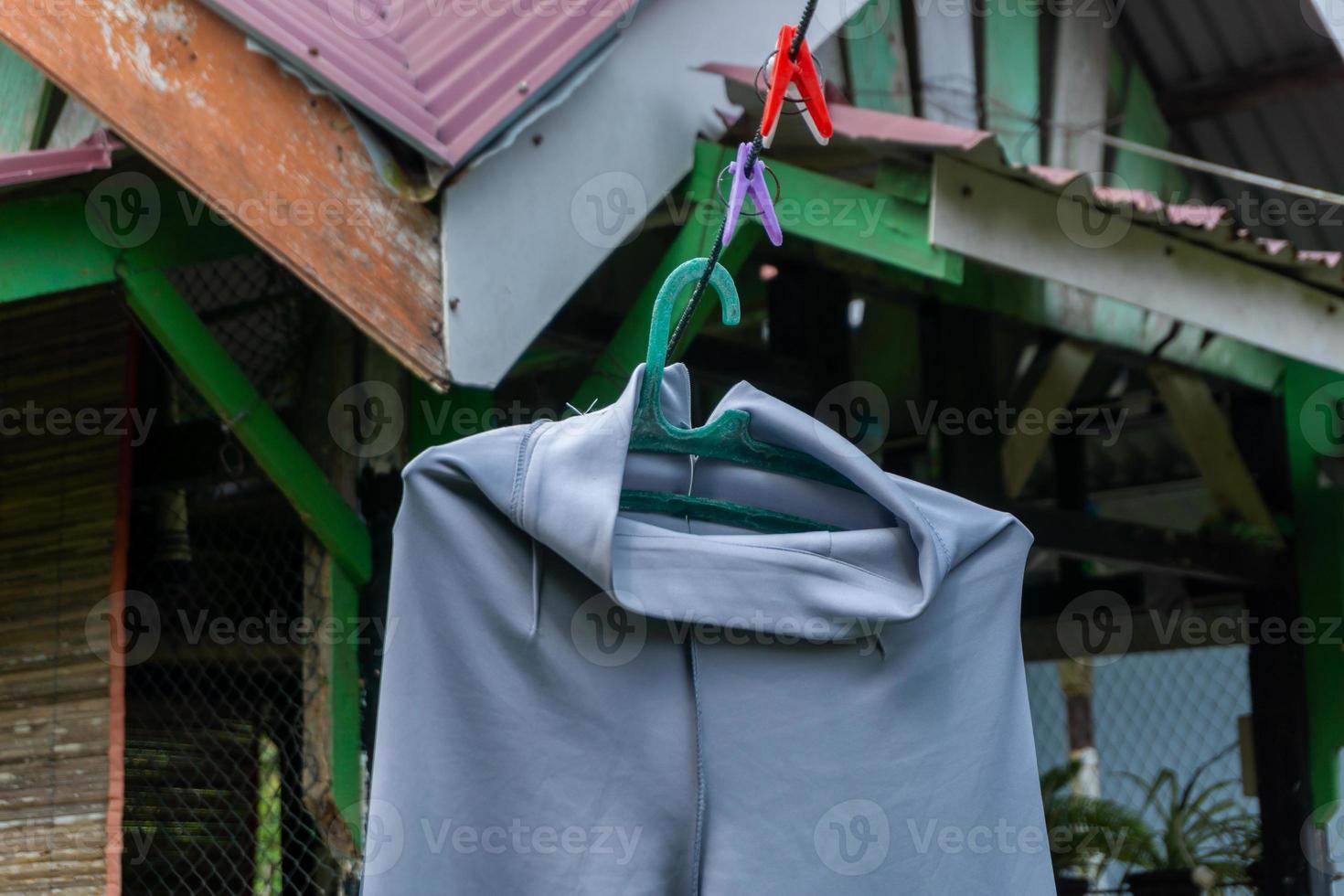 Clothes hanging in clothesline at sunny day photo