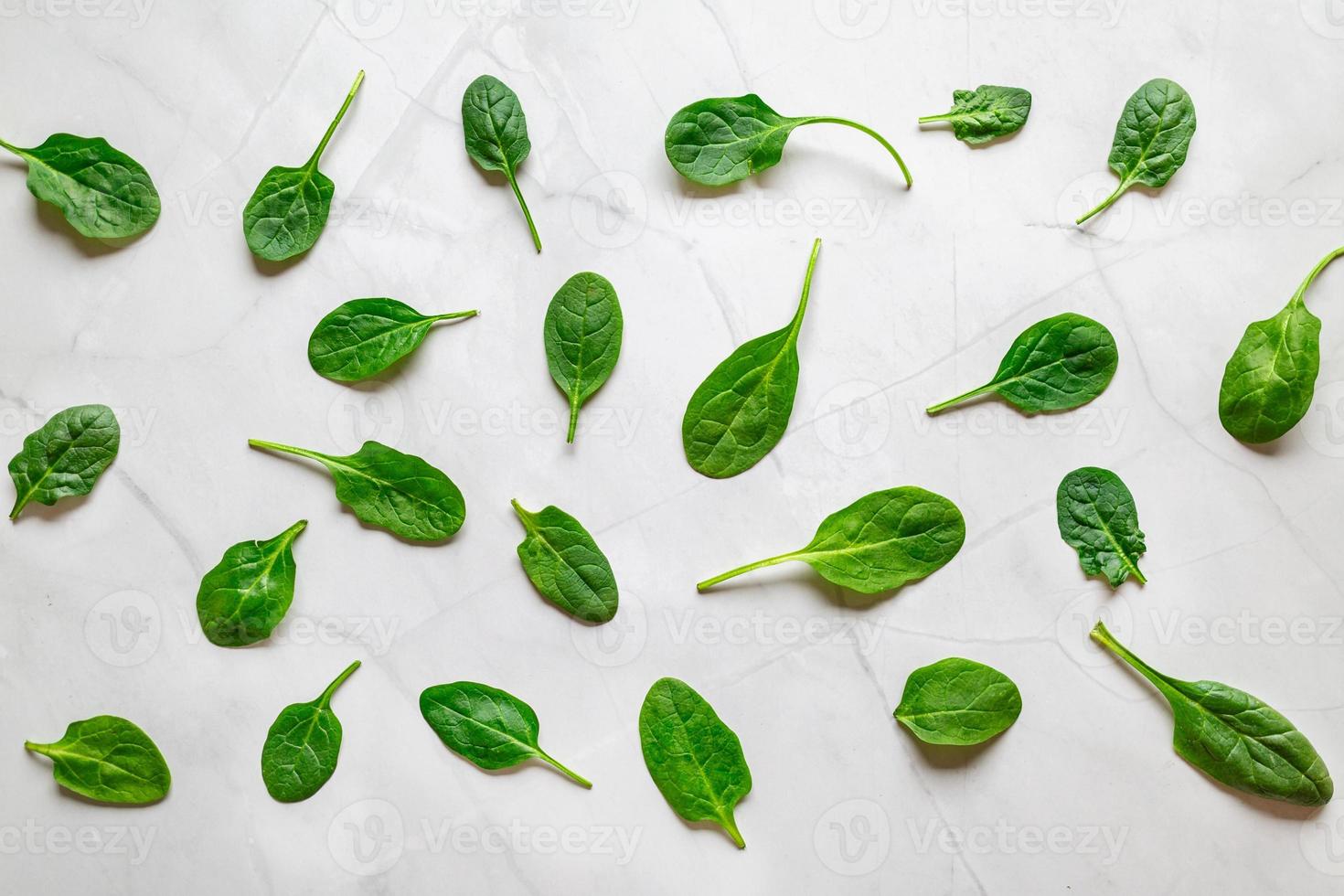 Spinach pattern background on white marble. Top view, Fresh Green spinach pattern food on light surface photo