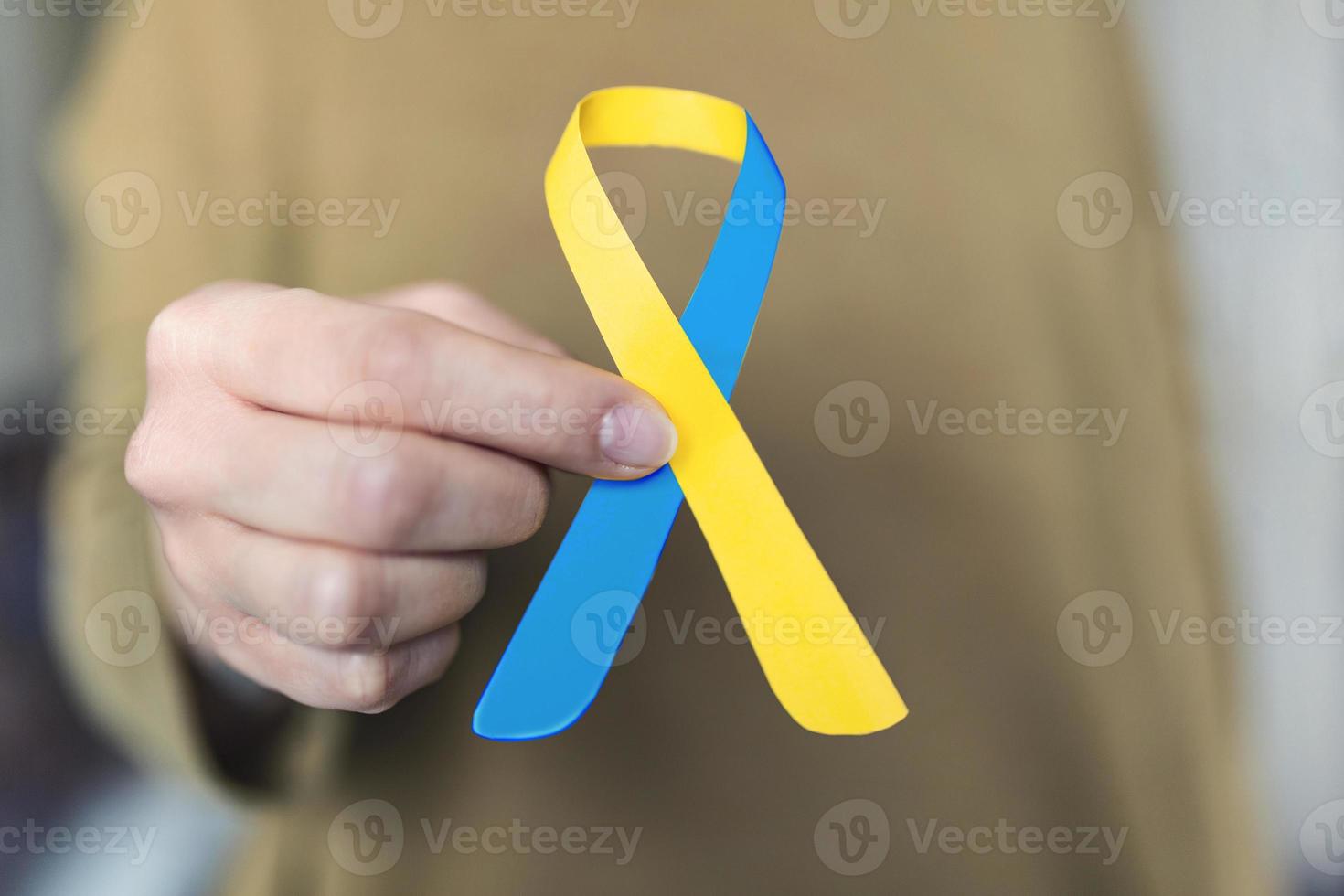 Close-up view of female doctor holding Down Syndrome Day ribbon photo