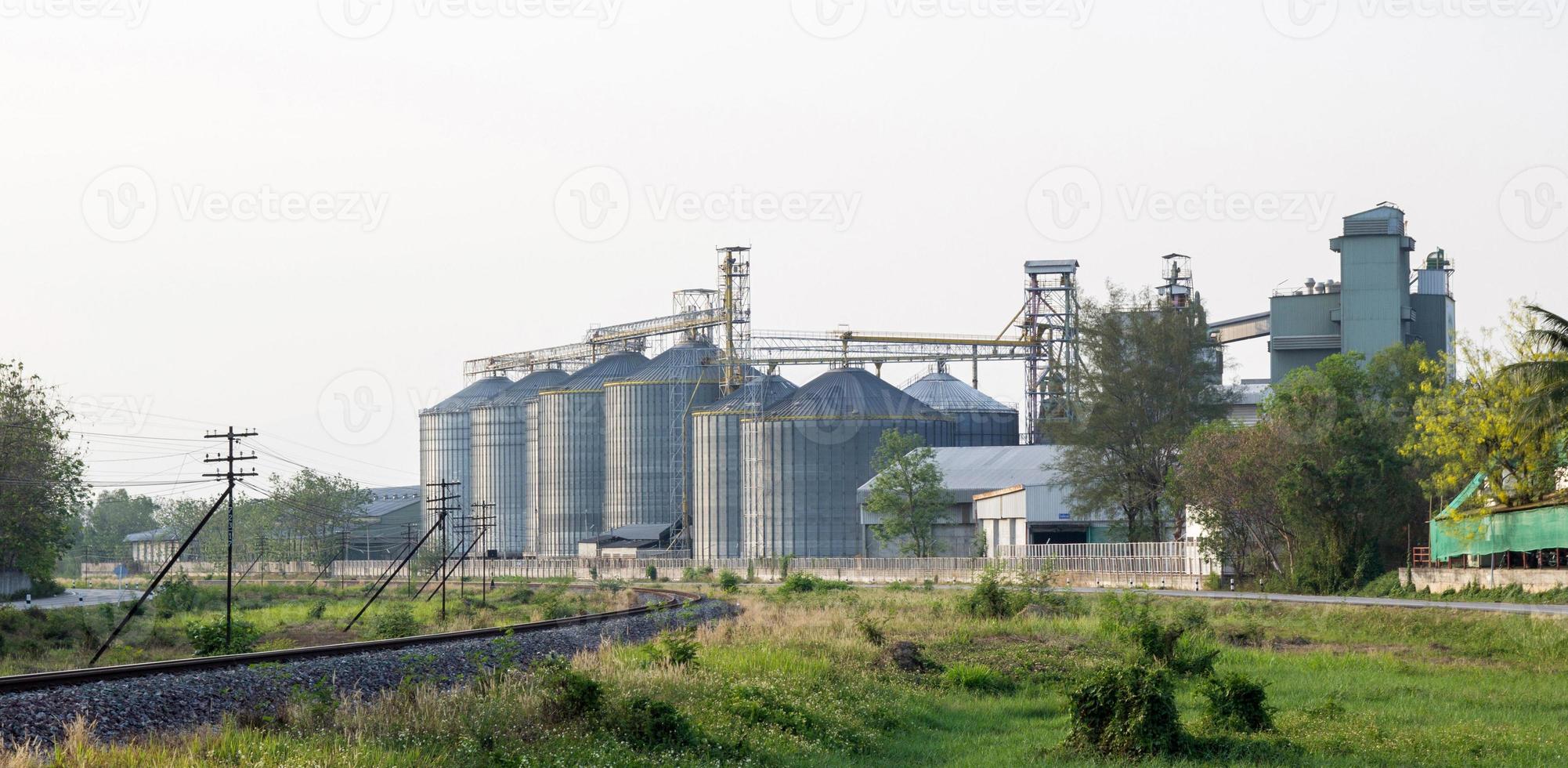 food industry building with agricultural silos and railway in the city photo
