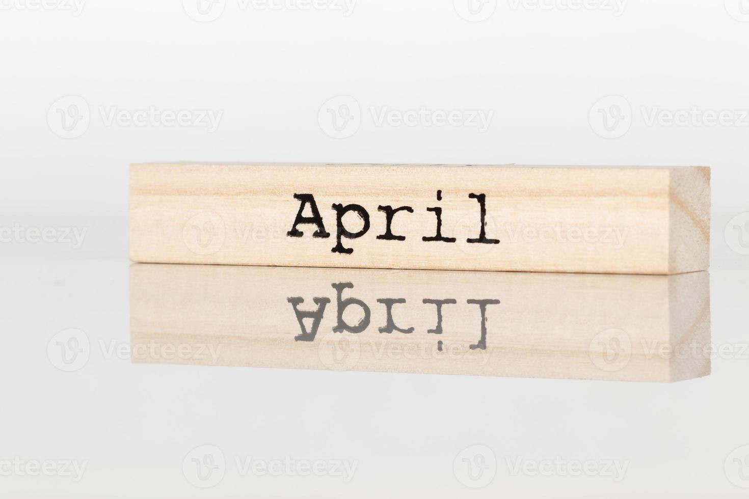 wooden cube with an inscription April on a white background photo