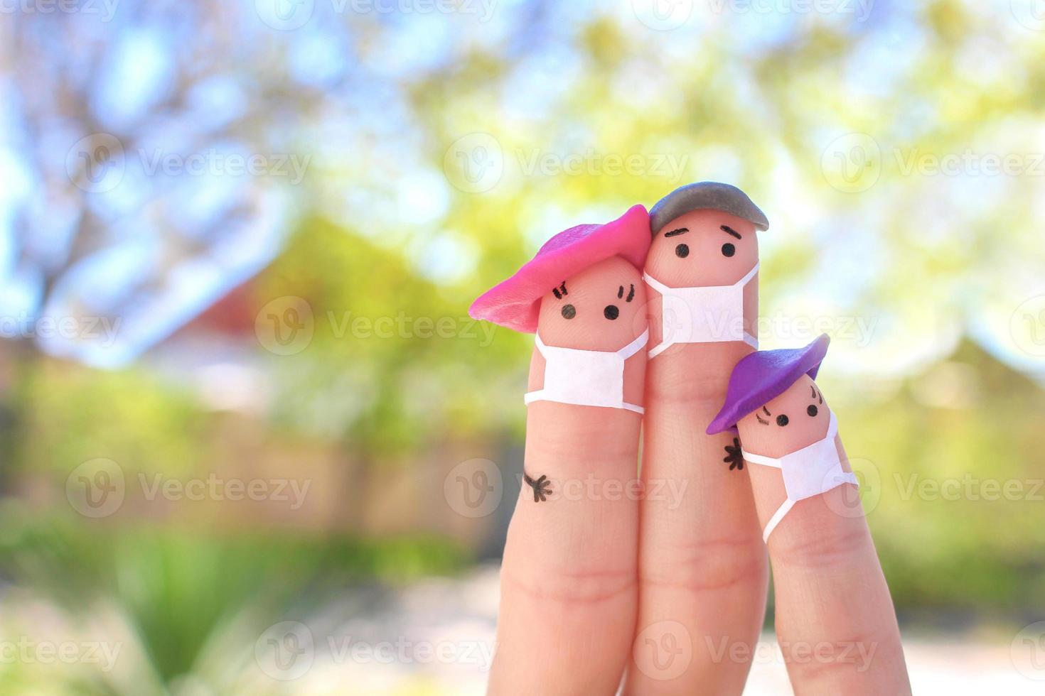 Fingers art of family with face mask on walk. photo