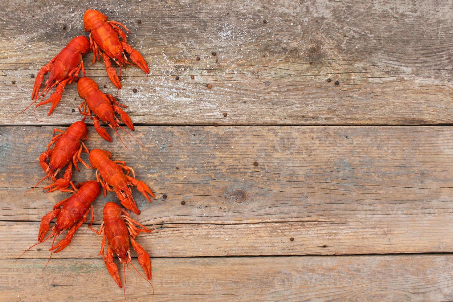 Crawfish on the old wooden background. Top view. photo