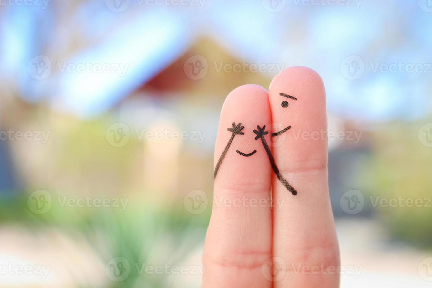 Fingers art of Happy couple. Boy closed her eyes to girl. Concept of girl guessed who closed his eyes. photo