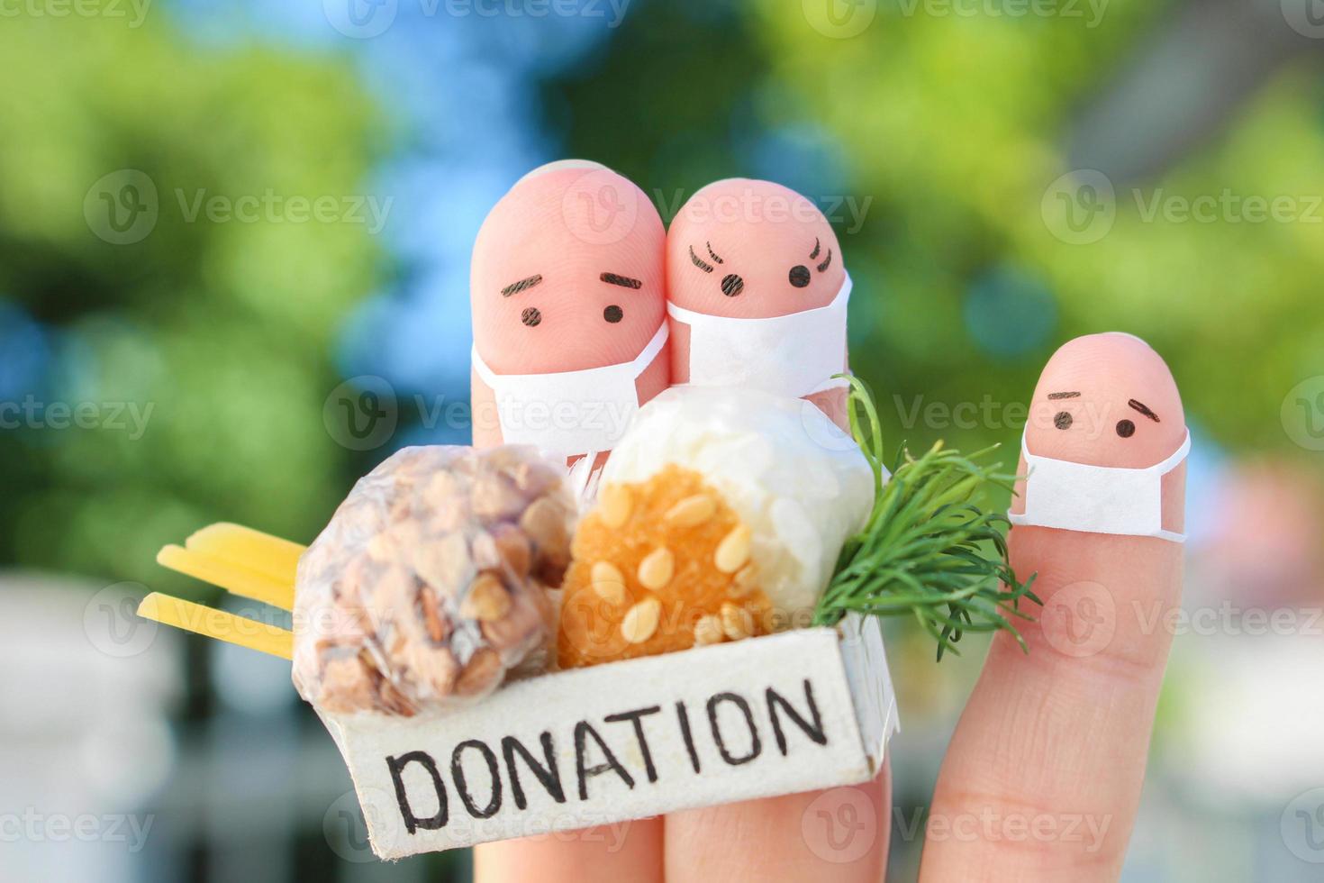 Fingers art of family with face mask. Man  and woman holding donation box with food. photo