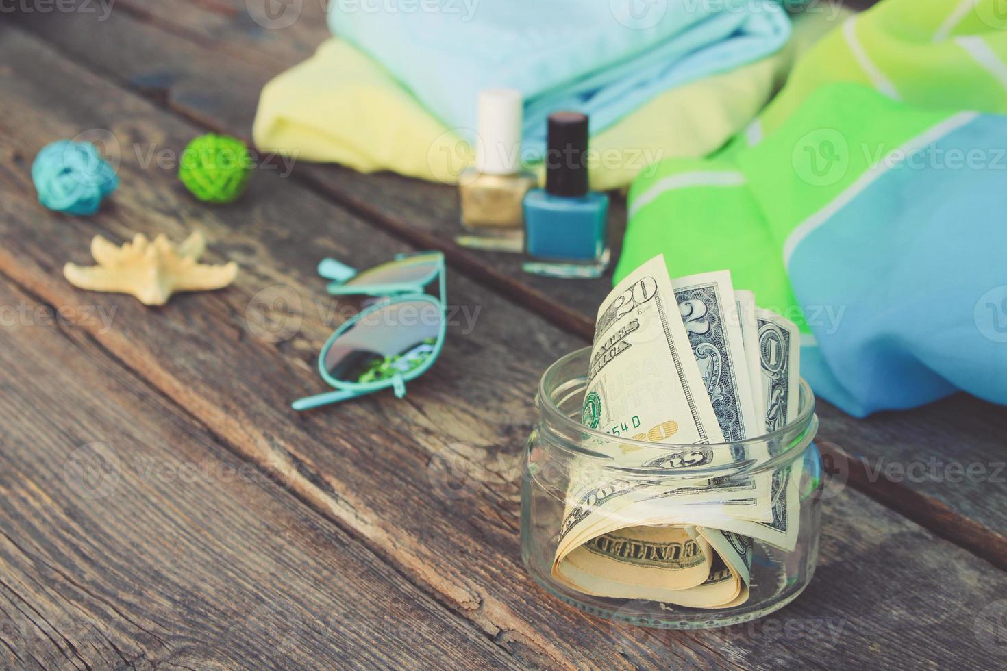 Dollars in glass jar. Concept of collecting money for journey. Toned image. photo