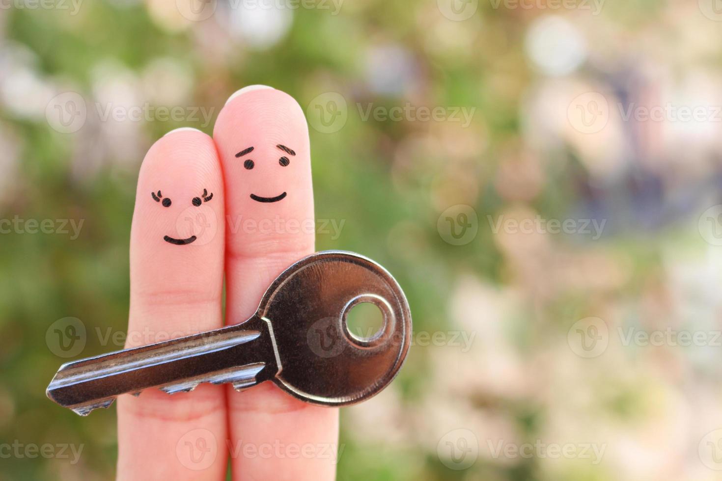Fingers art of happy couple. Family holds house key. photo