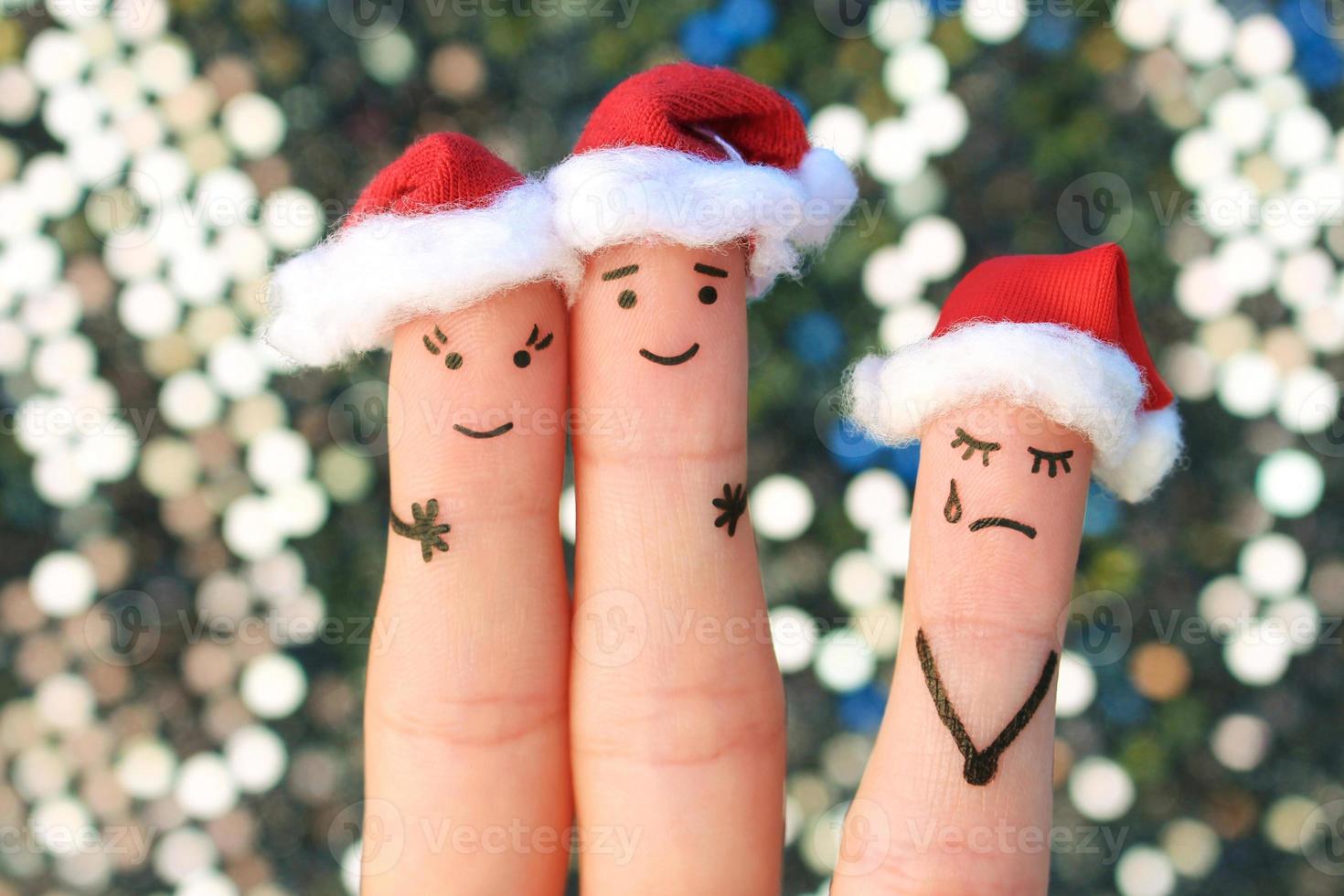 Fingers art of happy couple laughing in New Year hats. Woman is angry and jealous. Fingers art of couple celebrates Christmas. photo