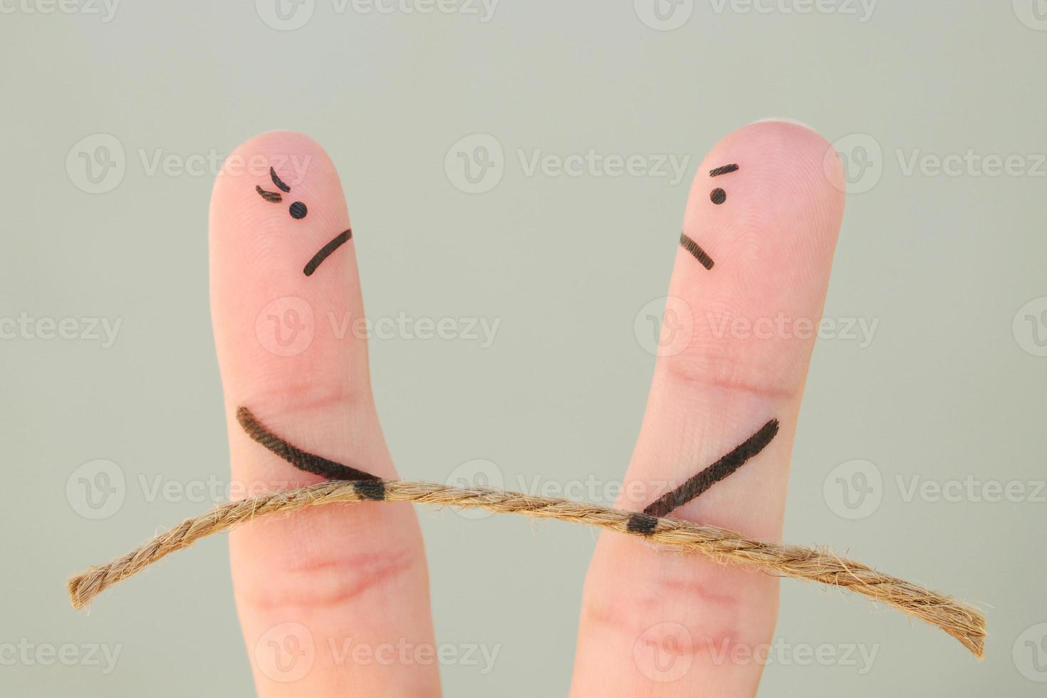 Fingers art of couple. They playing tug of war with rope. photo