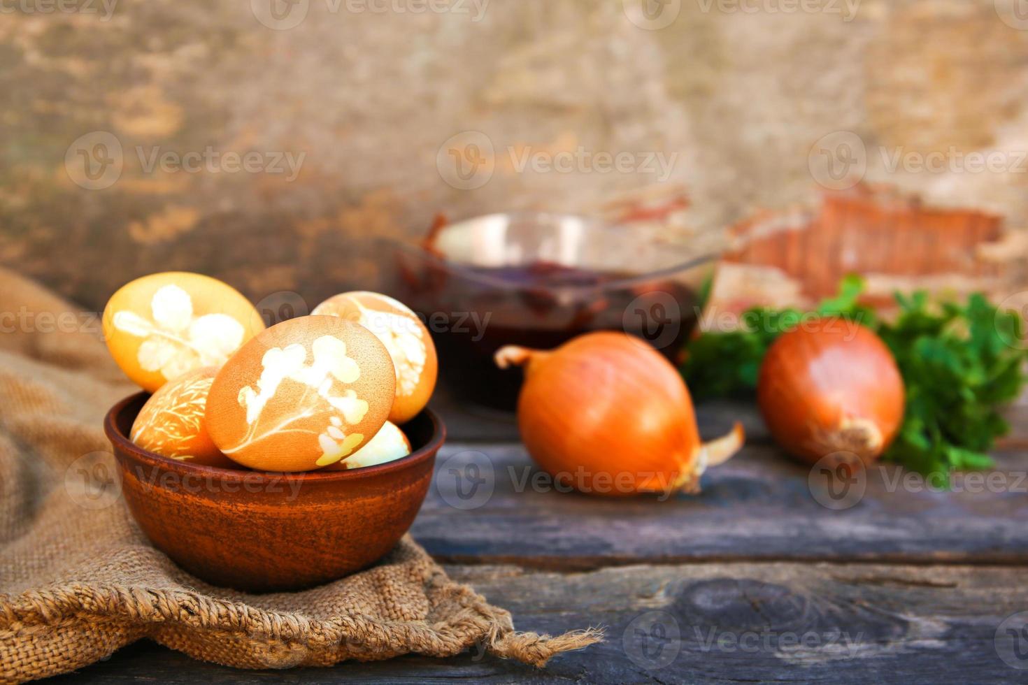 Easter eggs with pattern colored with onion peel on old wooden background. photo