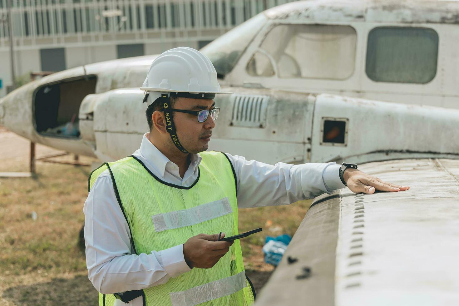 Aircraft mechanic examining airplane wing photo