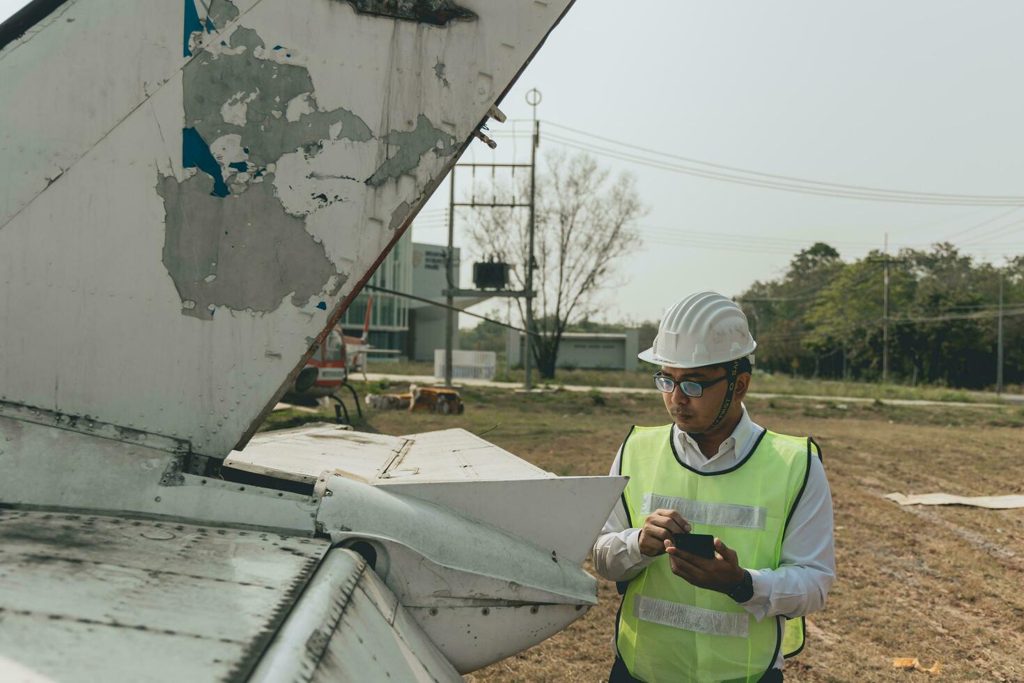 Aircraft mechanic examining airplane wing photo