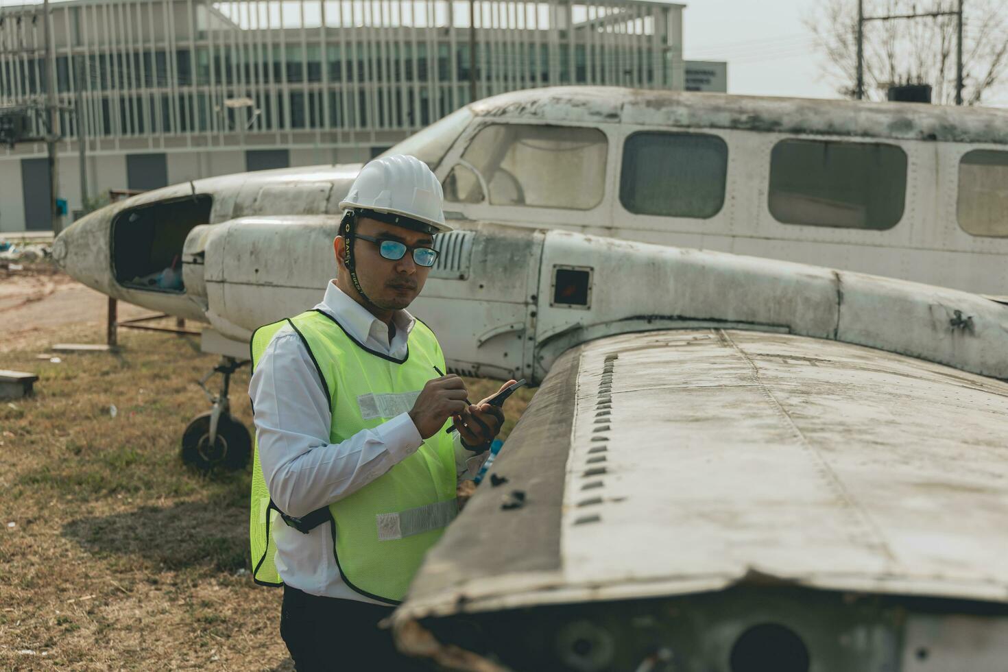 Aircraft mechanic examining airplane wing photo