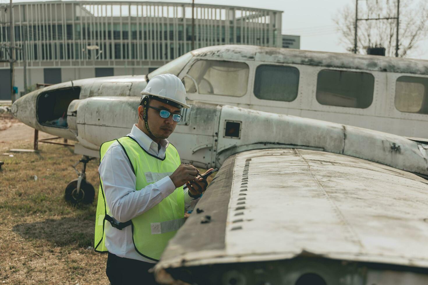 Aircraft mechanic examining airplane wing photo