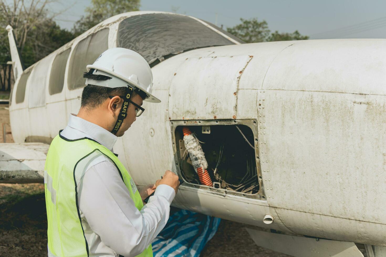 Engineer maintaining a helicopter Engine. Male engine machanic helicopter checking helicopter before take off photo