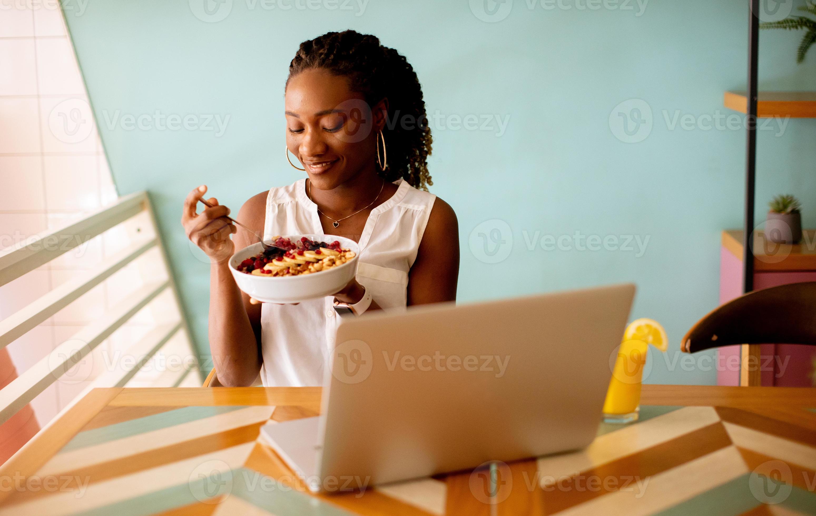 Young Black Woman Having A Healthy Breakfast While Working On Laptop In 7-healthy-and-quick-breakfast-ideas-in-under-20-mins