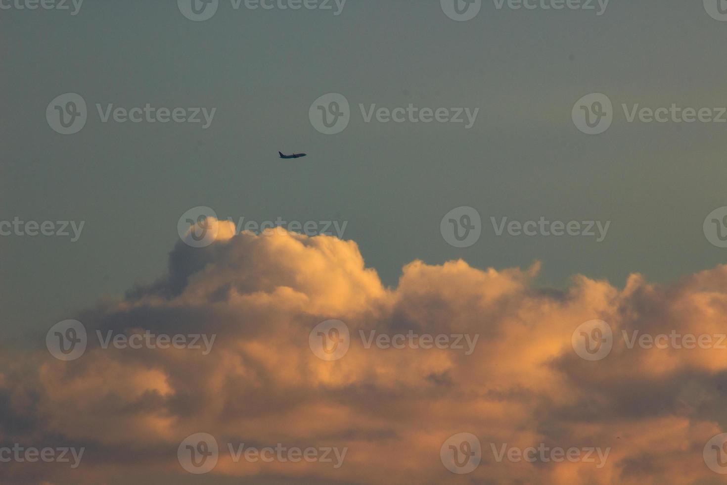 Plane in the sky at sunset photo