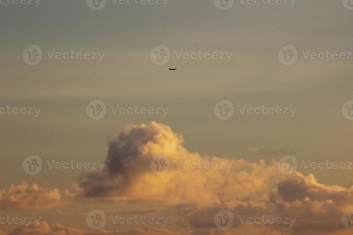 Plane in the sky at sunset photo