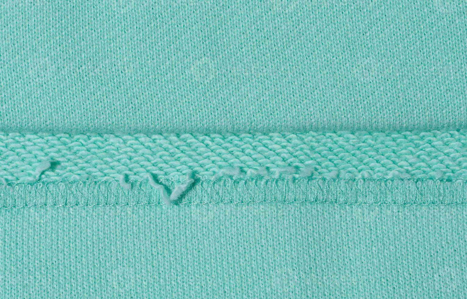 Cotton mint-colored fabric texture for making clothes, close up photo