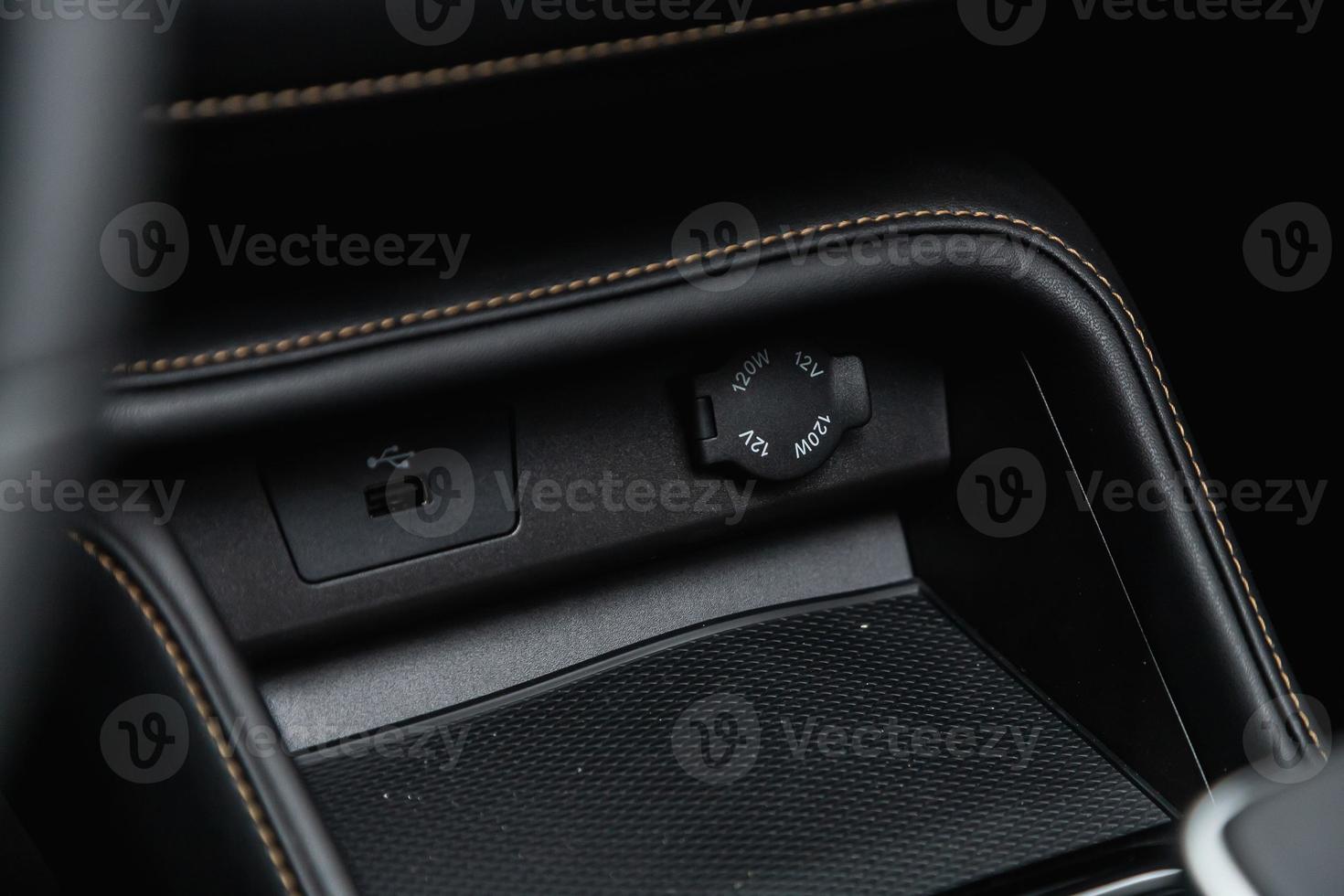 Close up of a charging in the car,  usb connector . modern car interior photo