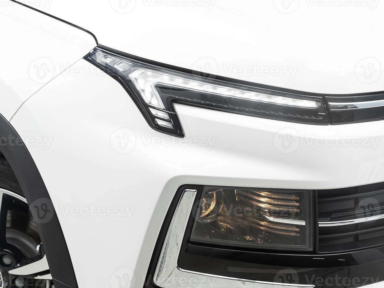 view of the front  of the car. White  car headlight. photo