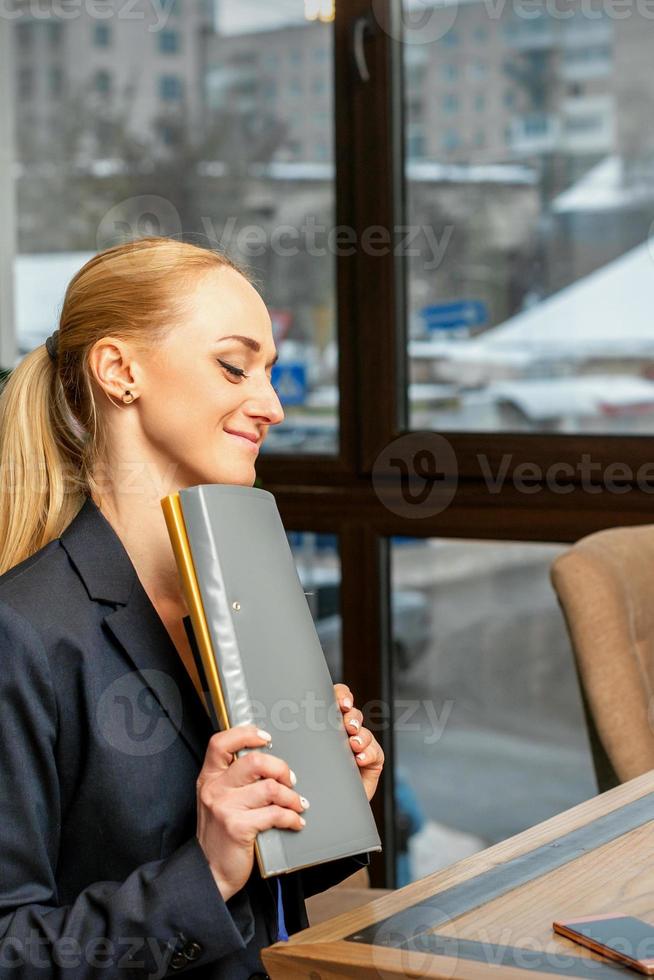 Businesswoman with folder with documents photo