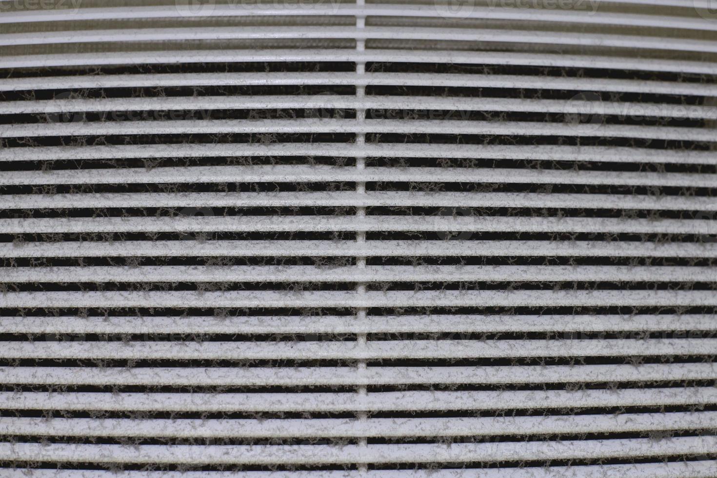Dirty air ventilation grill of HVAC with clogged filter. photo