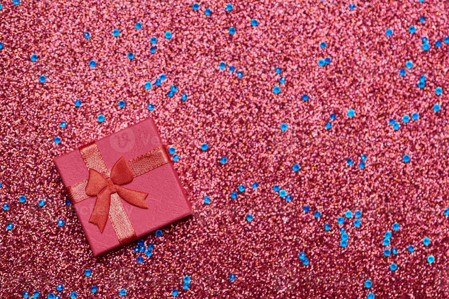 Red gift box in festive tinsel photo