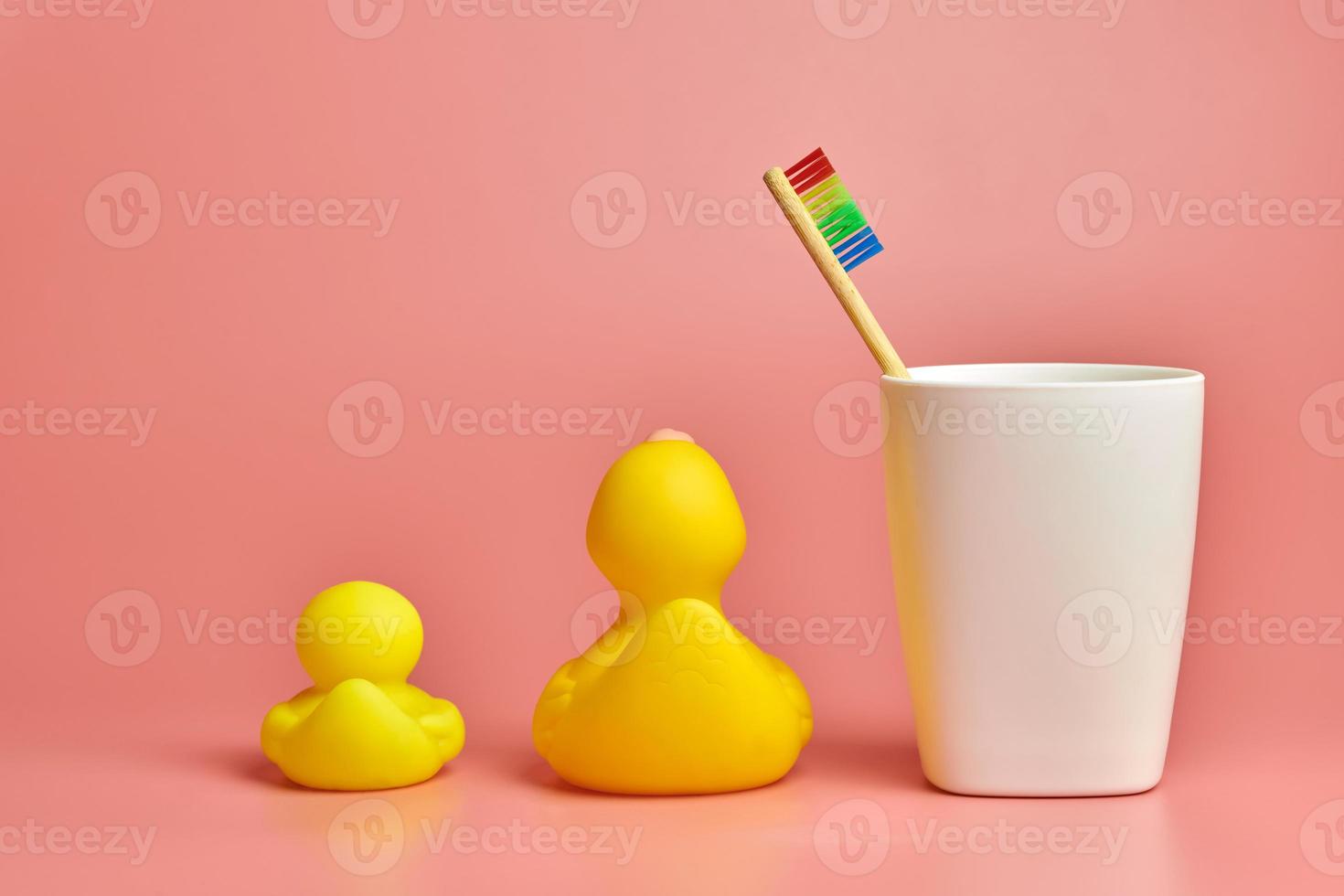 Eco bamboo toothbrush and duck toys. Personal care tool for protect oral cavity, remove plaque and tartar. photo