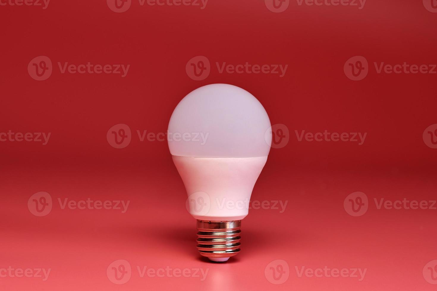 Light bulb, copy space. Energy saving minimal idea concept.Pink background. photo