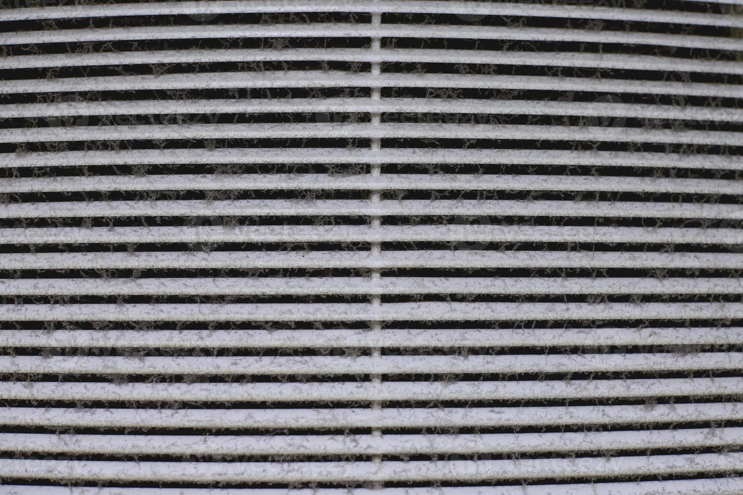 Dirty air ventilation grill of HVAC with clogged filter. photo