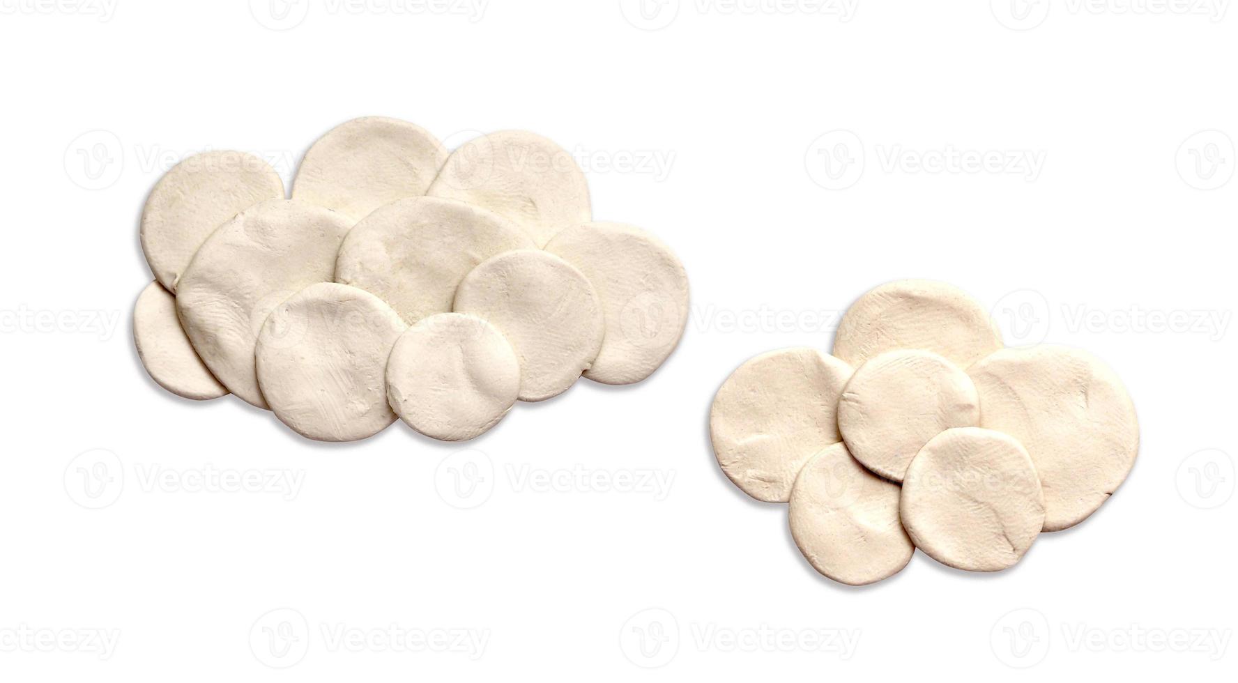 two clouds from plasticine on a white background photo