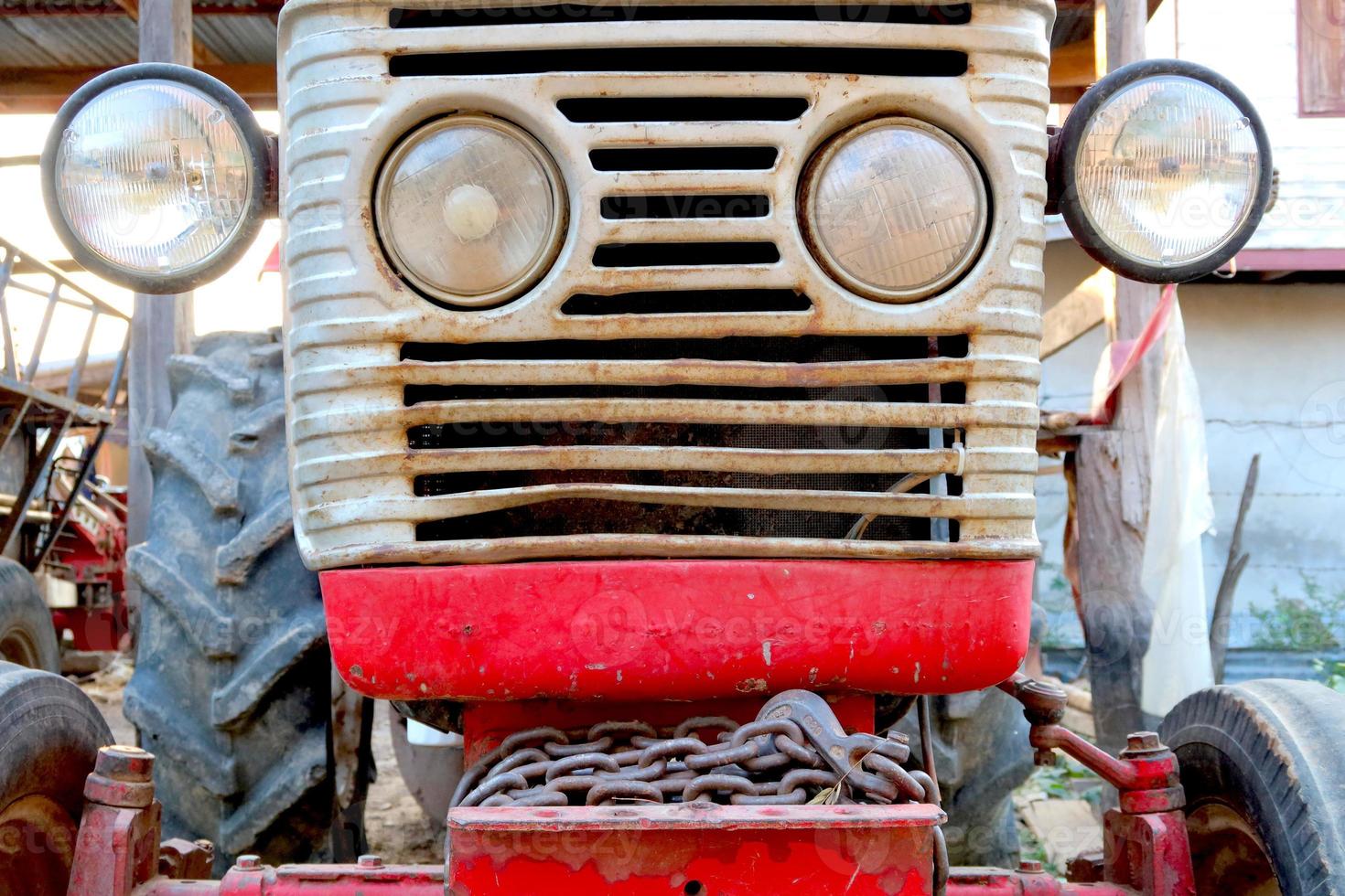 Red tractor. The concept of work in a fields and agriculture industry. photo