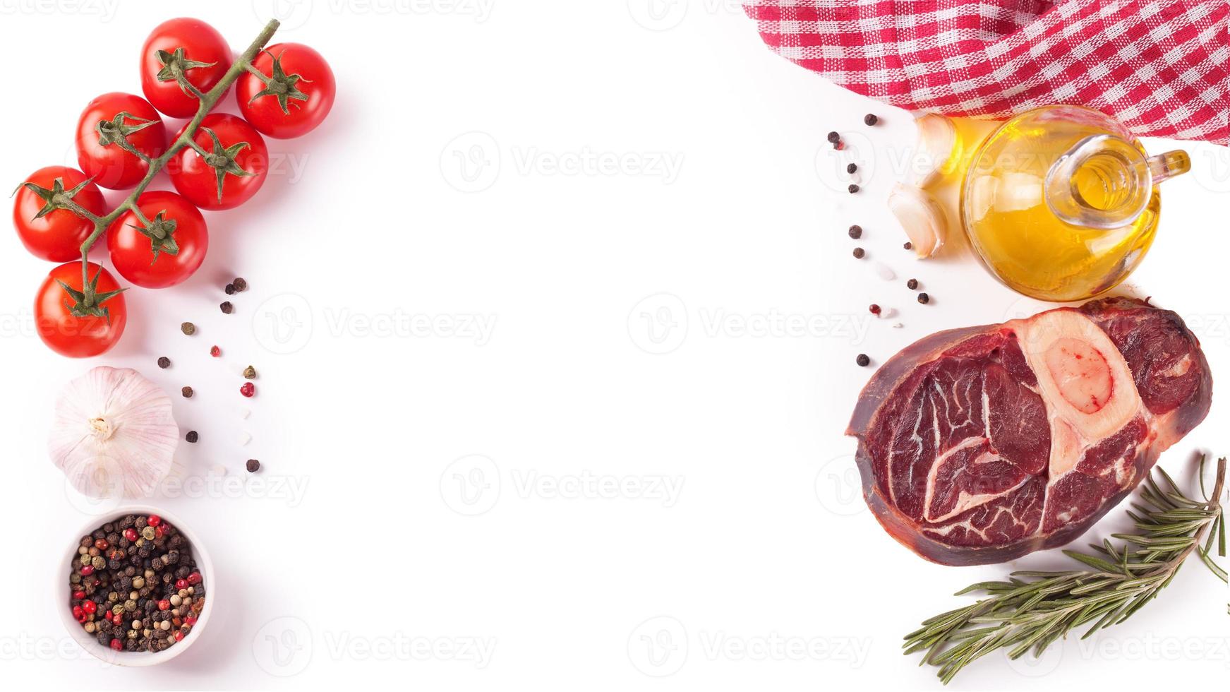 raw beef steak with bone and ingredients for cooking isolated on white. photo