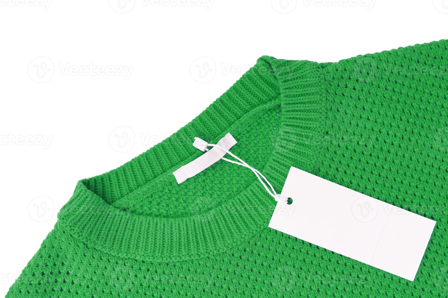 White blank rectangular clothing tag on green knitted sweater isolated on white background photo
