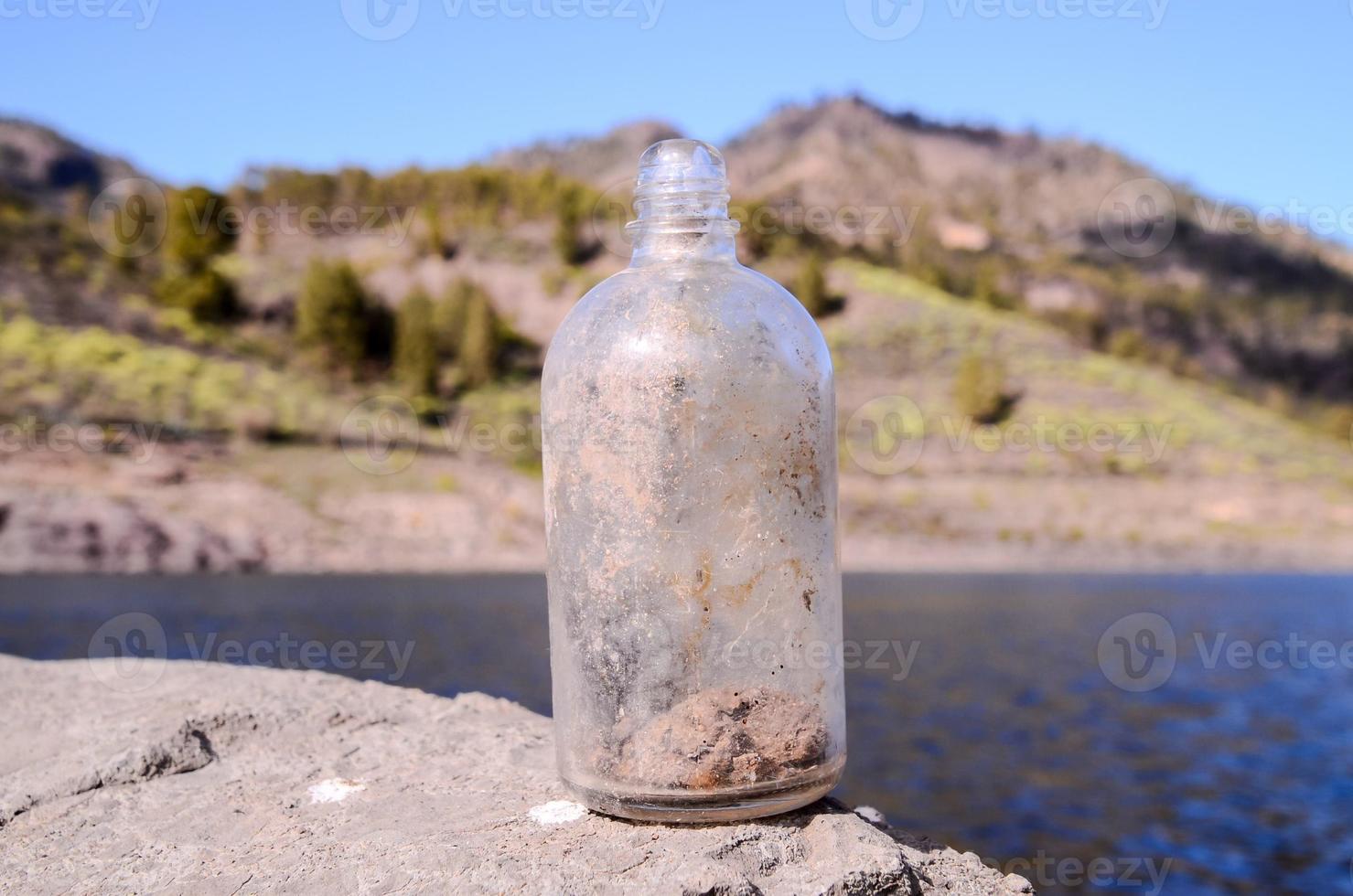 Bottle on the rock photo