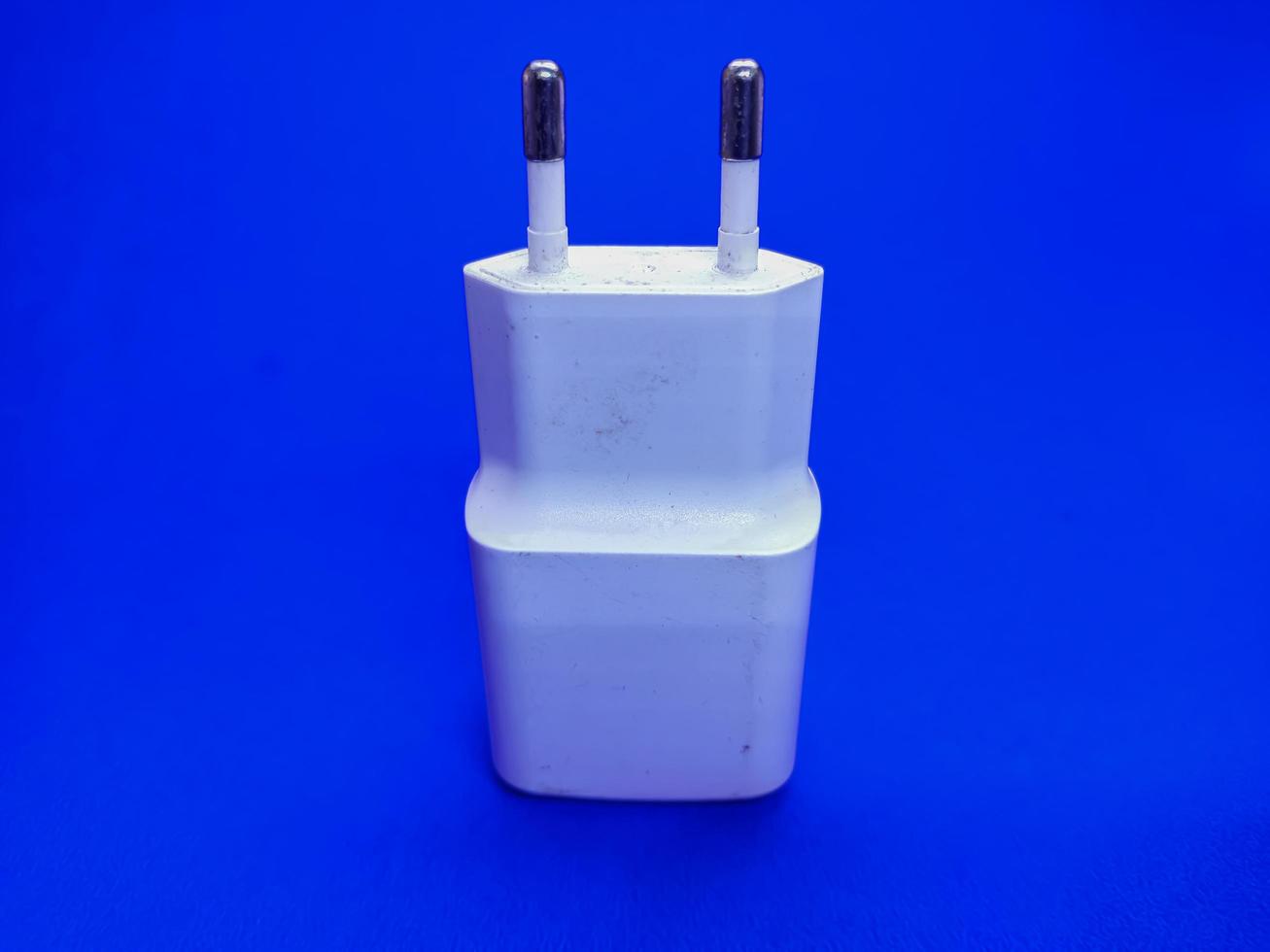 white smartphone charger isolated with blue background picture photo