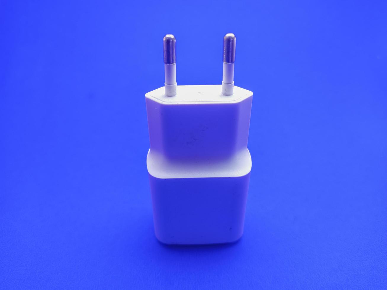 white smartphone charger isolated with blue background picture photo